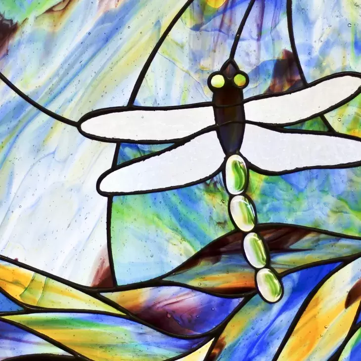 Stained glass featuring a dragonfly.