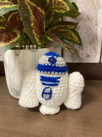 A crocheted stuffy of R2D2
