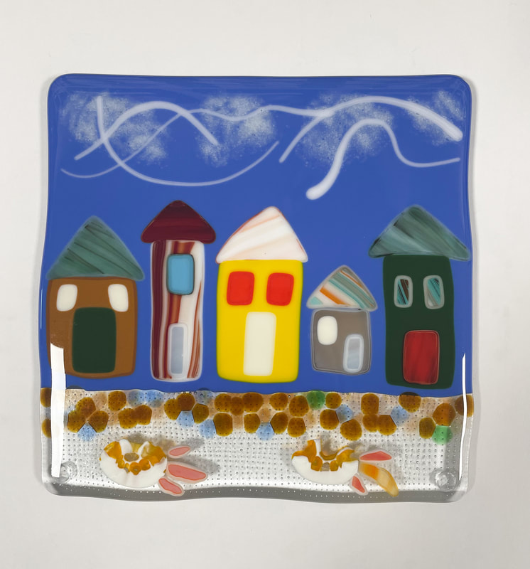 A glass tile featuring houses.