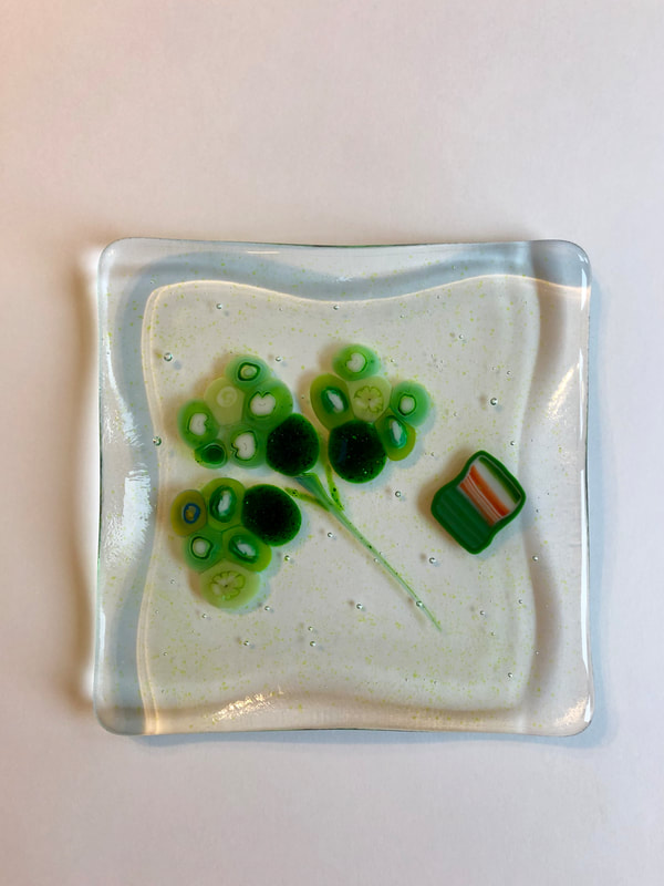 A glass tile featuring green blobs.