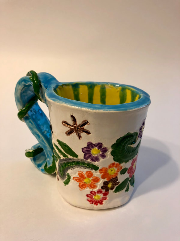 A mug featuring flowers on it.