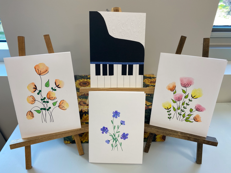 A collection of cards with flowers and a piano on them.