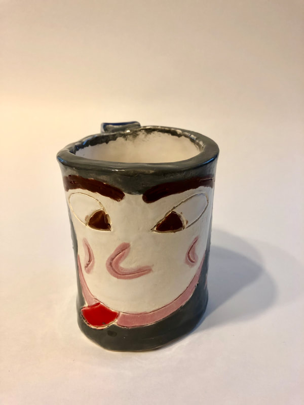 A mug featuring a face.