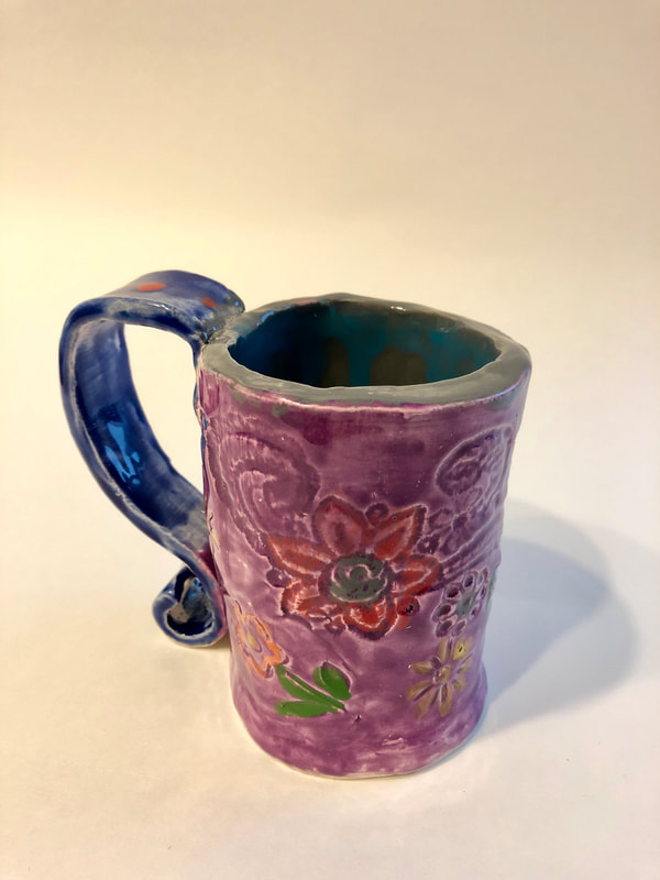 A purple mug with flowers.