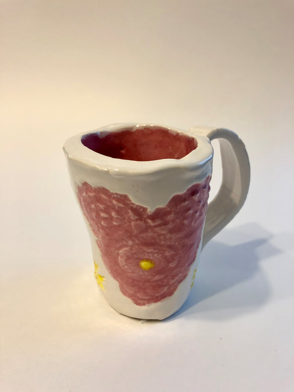 A white mug with a pink heart.
