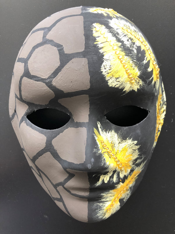The left side of the mask represents the time immediately after the injury, and the years of symptoms that have followed.  The world became overwhelming, dense, compressed, and difficult to navigate.  
