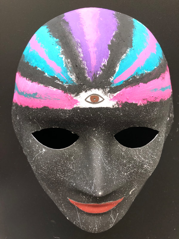 My mask is about looking inward to find peace and happiness as well as learning about myself, accepting and becoming aware of as many aspects about myself. The black is consciousness with beams of colour coming from within. 