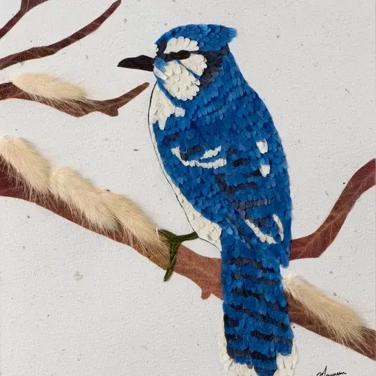 Pressed flower artwork featuring a blue jay.