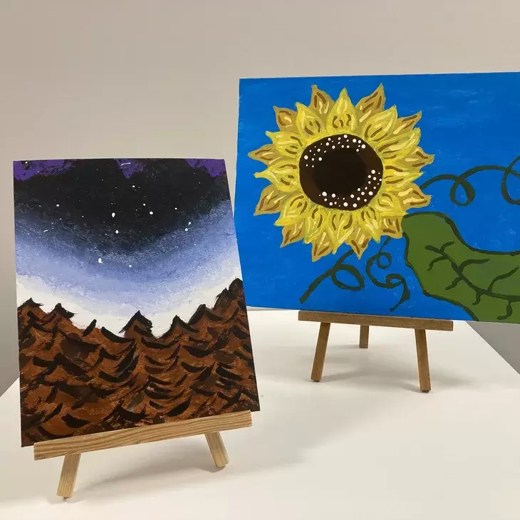 Two acrylic paintings of a  forest and a sunflower.